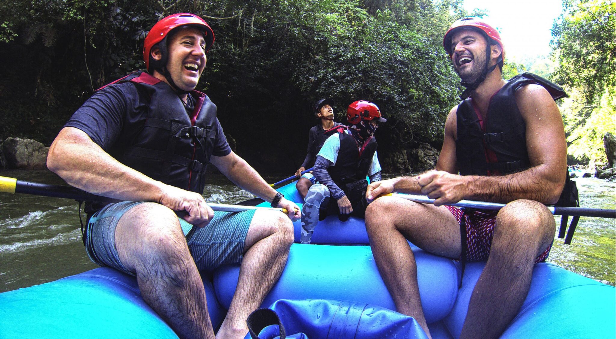 2 men laughing in a raft in Colombia