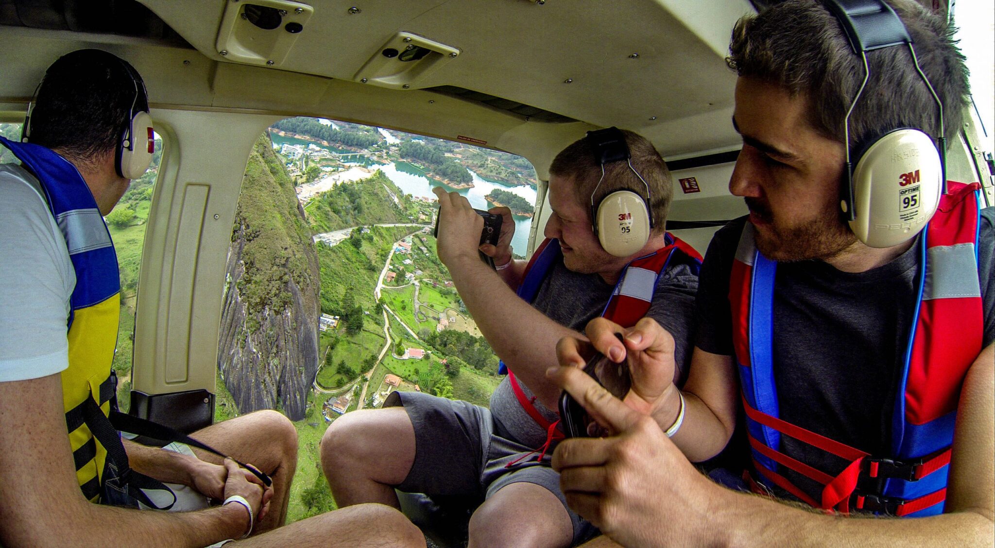 3 men sightseeing from helicopter