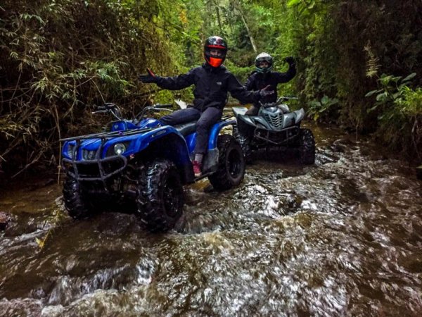 2 atv riders in a creek