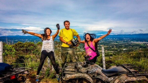 3 people jumping around quadbike