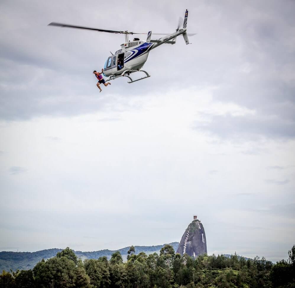 man jumping out of helicopter