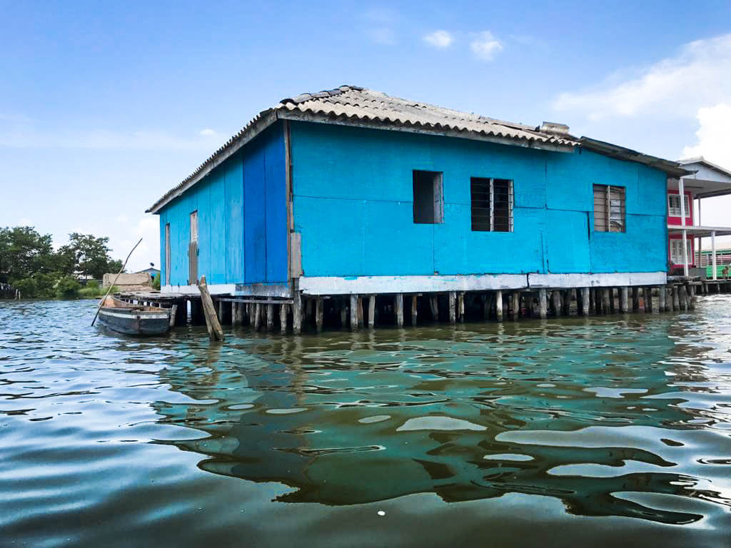 Blue house on stilts over water
