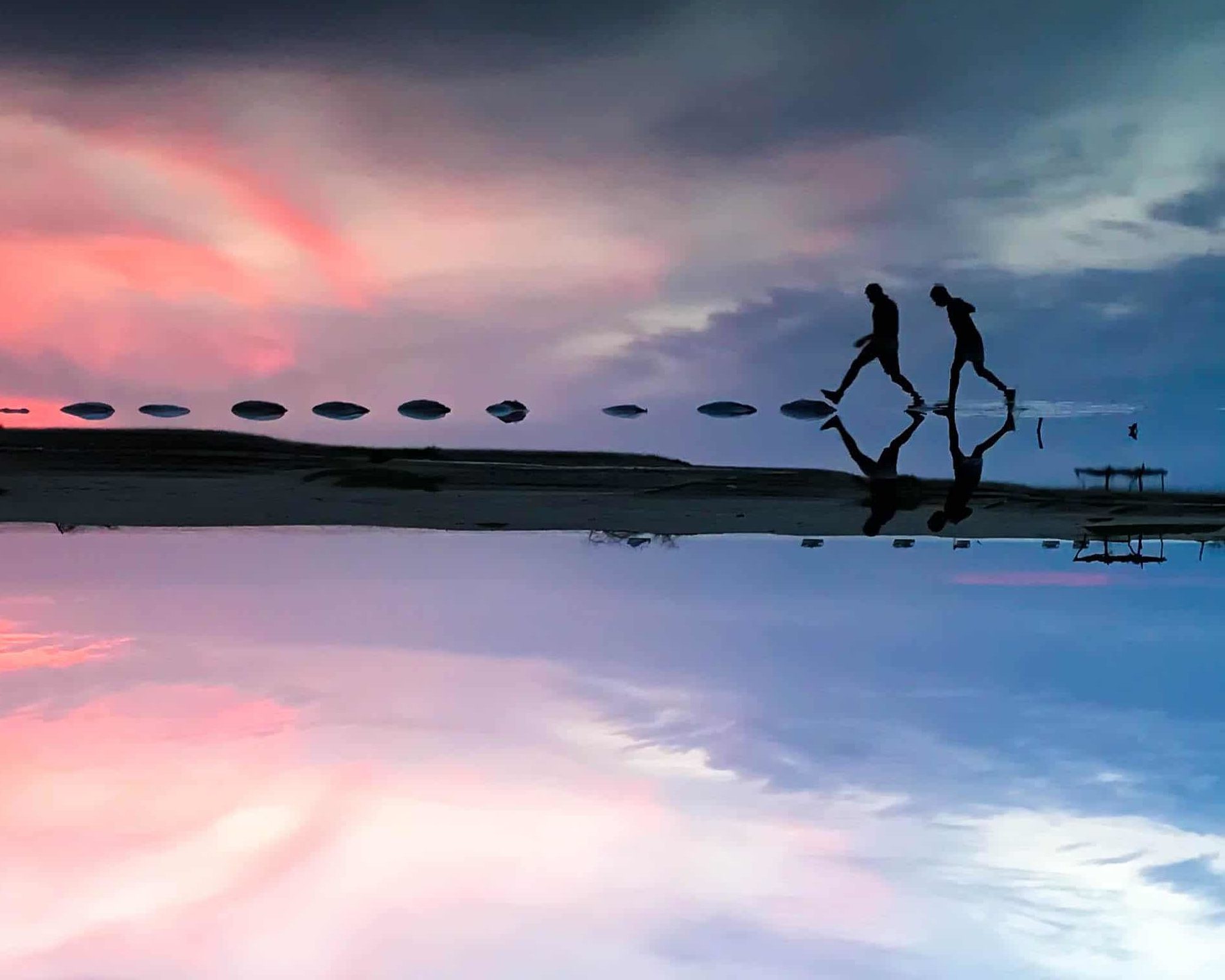 two persons walking on water during colombia tour