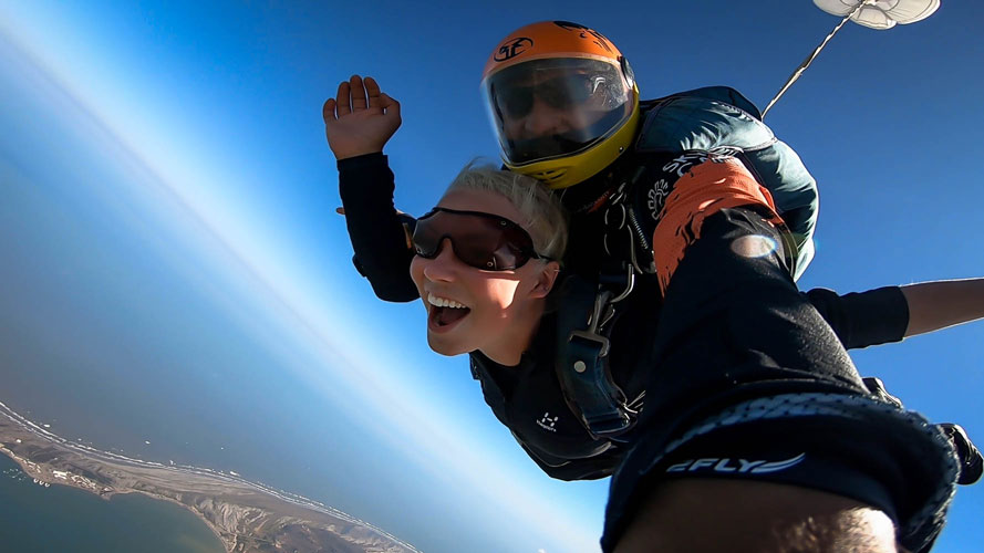 tandem skydiving over the ocean