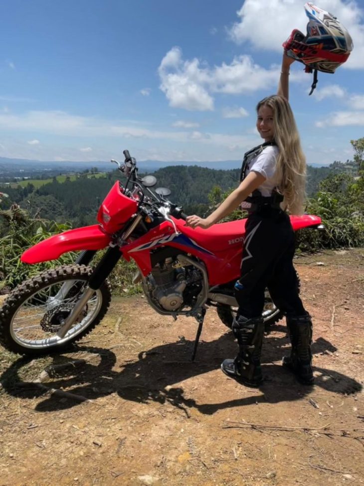 Blonde girl next to motorcycle