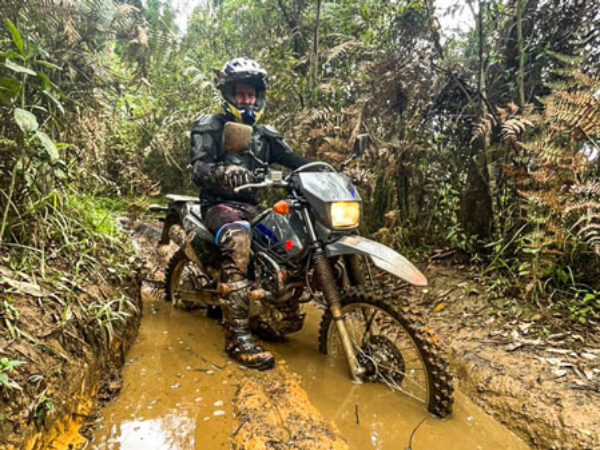 motorcycle in the mud on enduro tour