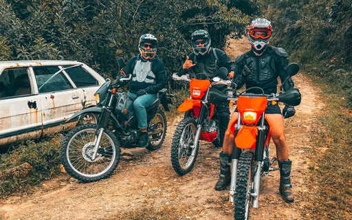 3 motorbikes on a dirt trail