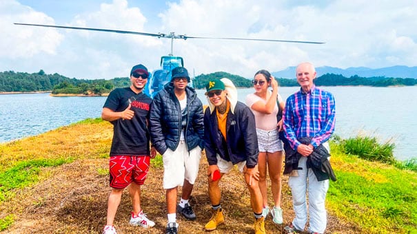 tour group standing in front of helicopter in helitour guatape