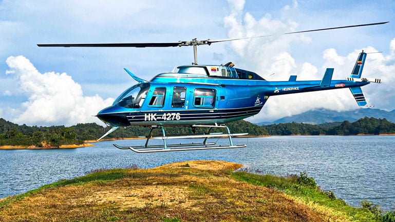 helicopter hovering for landing in medellin to guatape helicopter tour