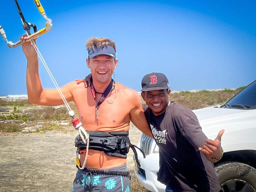 Two kitesurfers on the beach