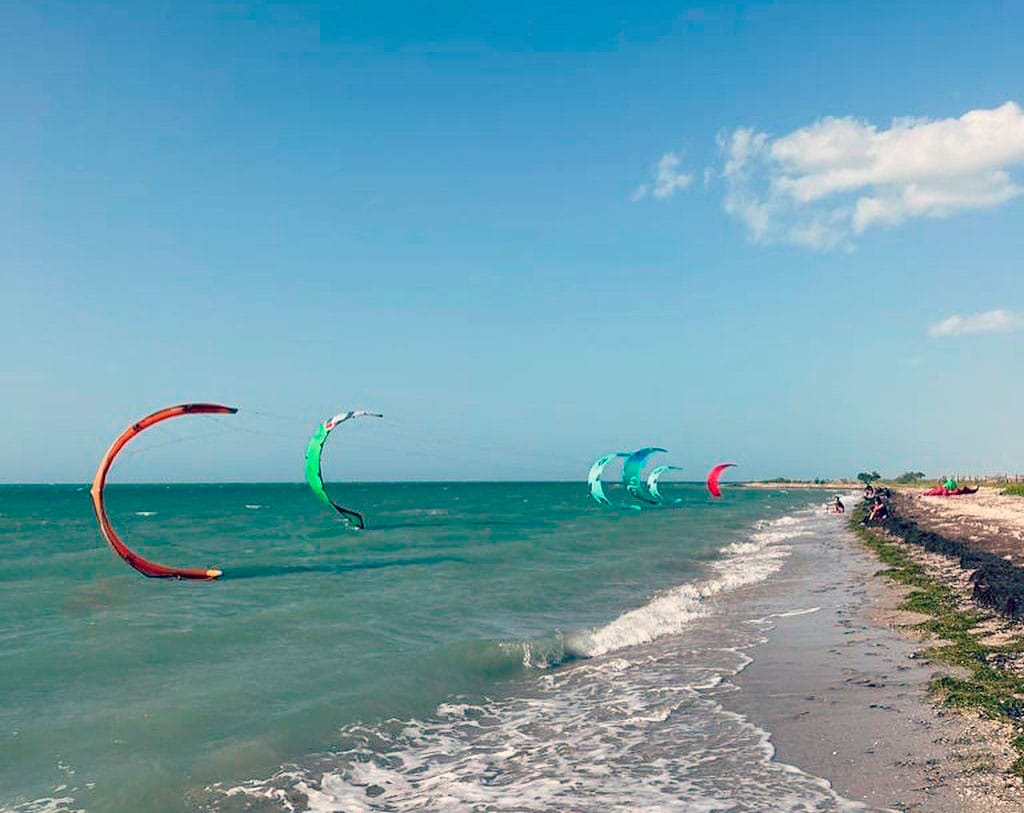 kitesurfers on a beach in Colombia