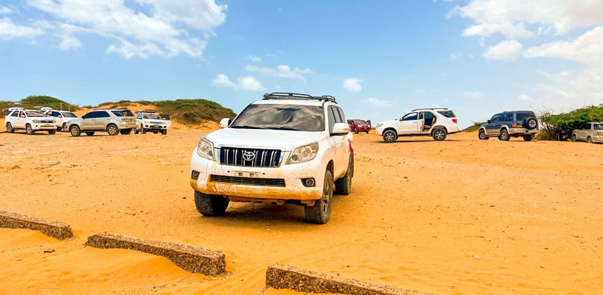 Toyota Land Cruisers parked in the desert of the Guajira